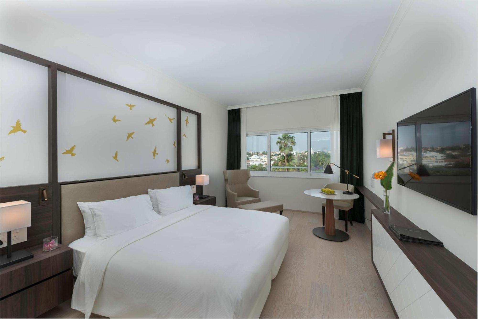 Zimmer mit Kingsize-Bett und Poolblick
